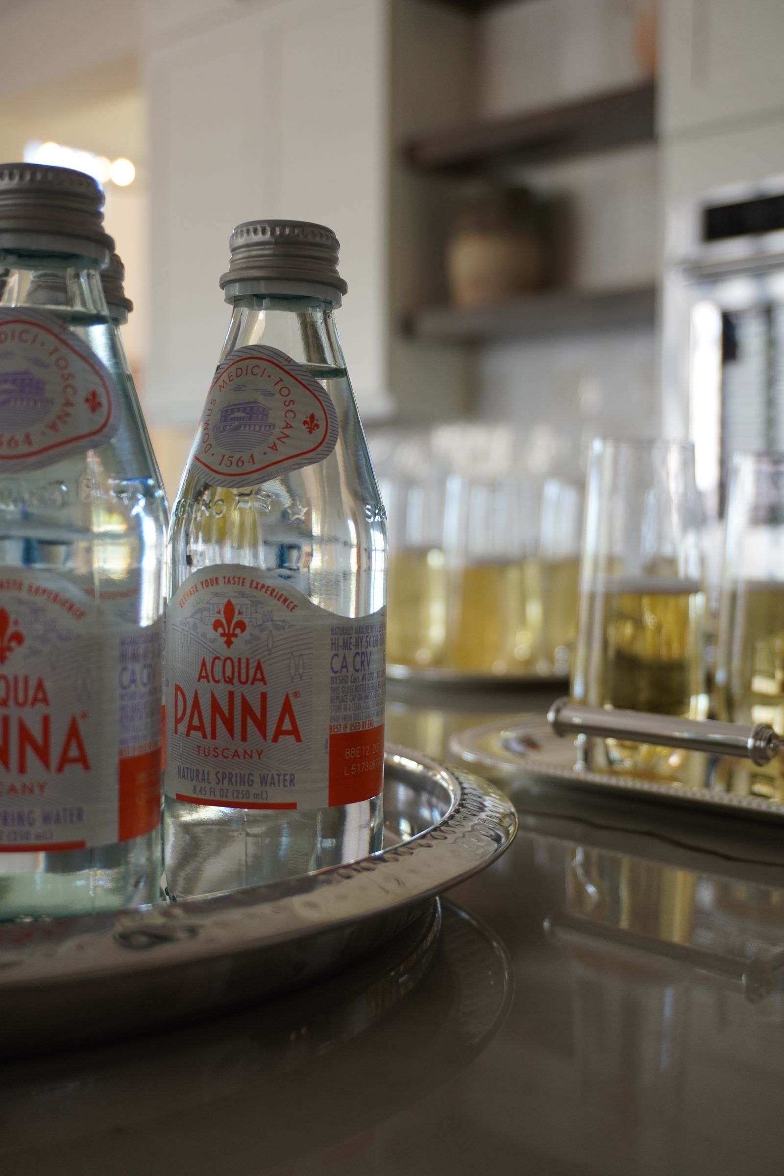 Acqua Panna natural spring water bottles beside champagne service