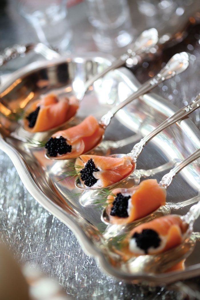 Smoked salmon and caviar on silver spoons