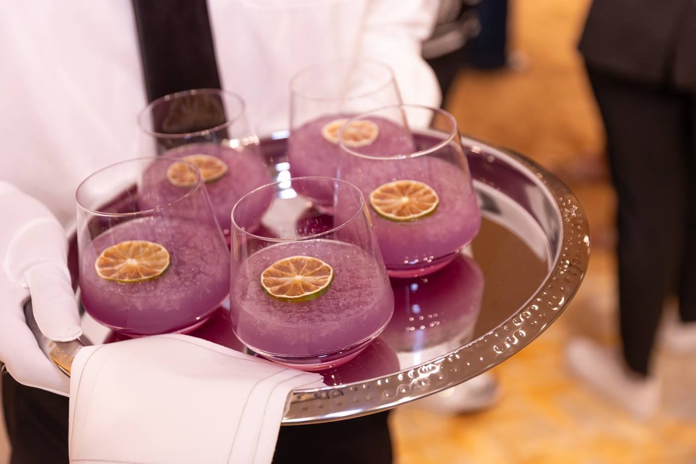 Purple cocktails on silver tray
