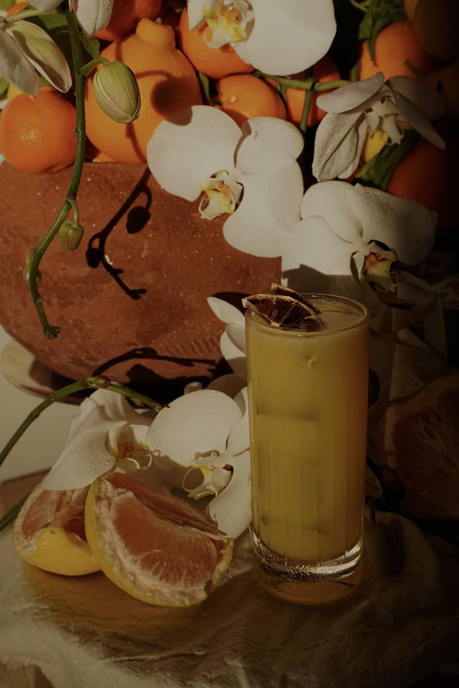 Citrus cocktail with orchids and fruit