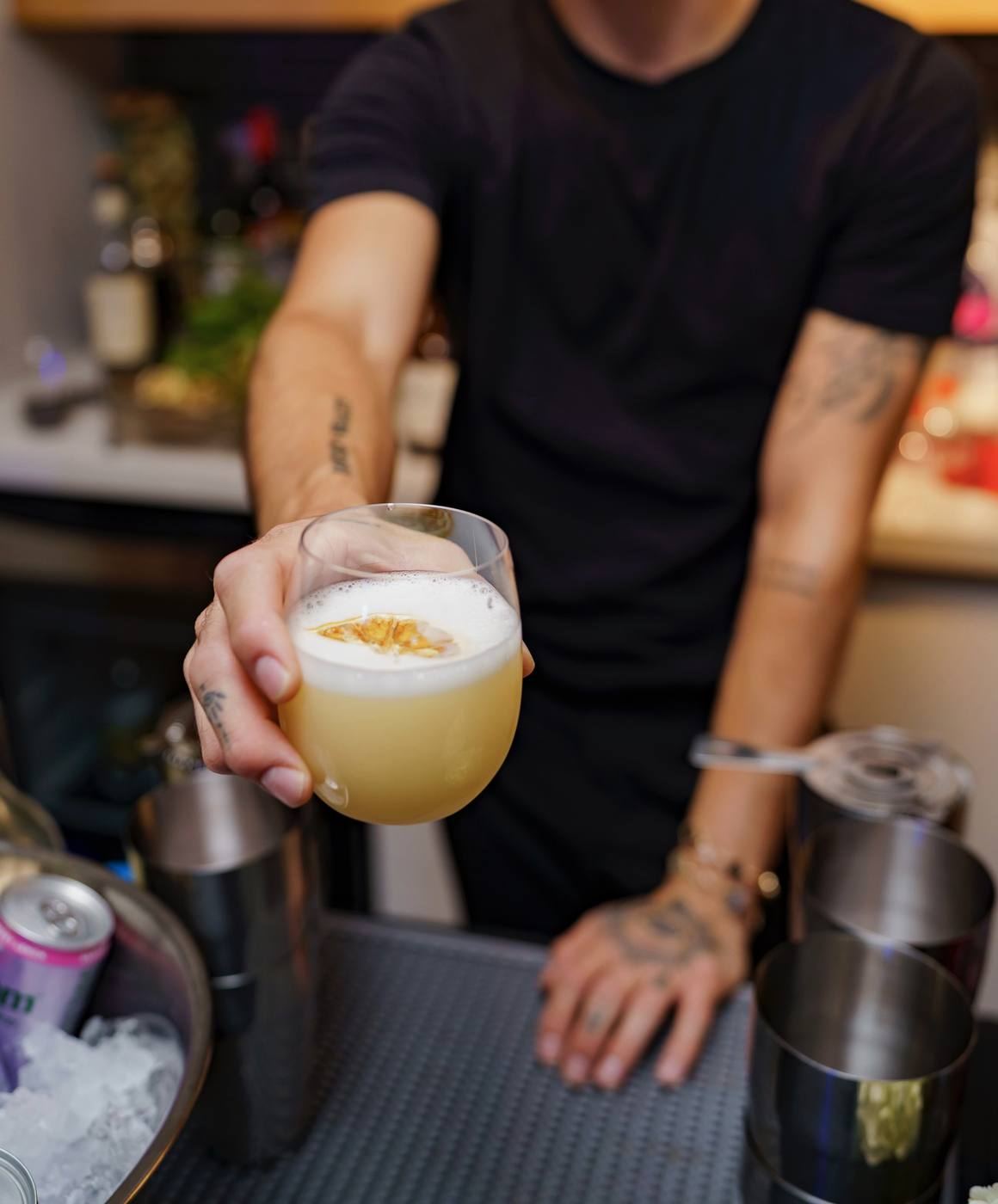 Bartender presenting foamy cocktail