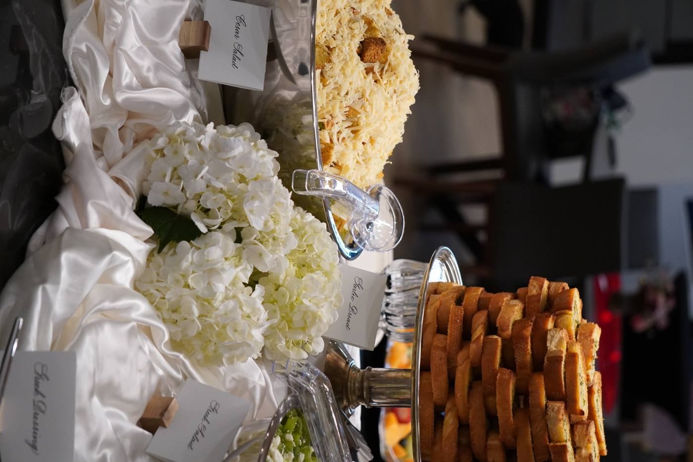 Caesar salad and garlic bread buffet station
