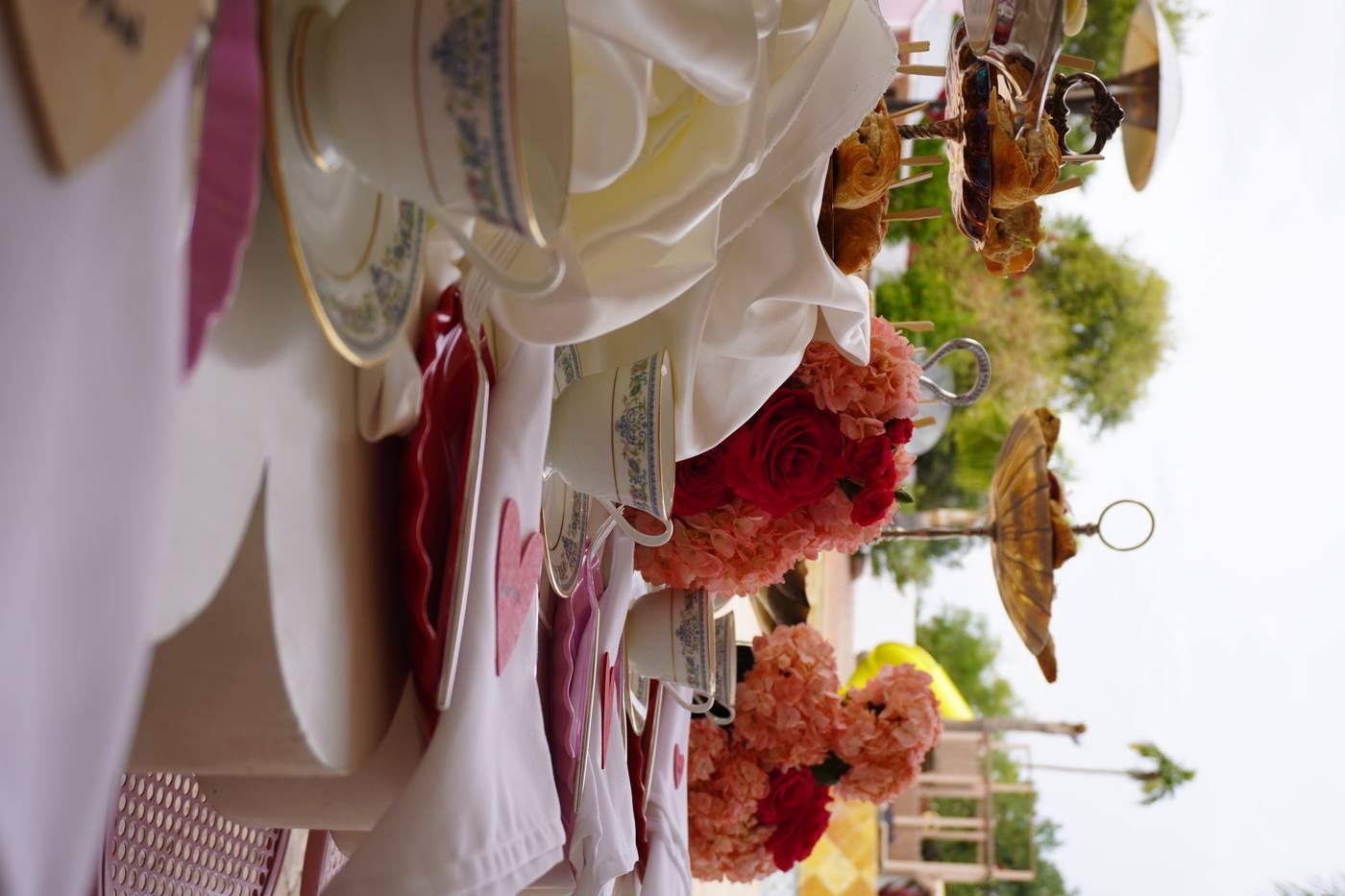 Valentine tea party table setting with teacups and florals
