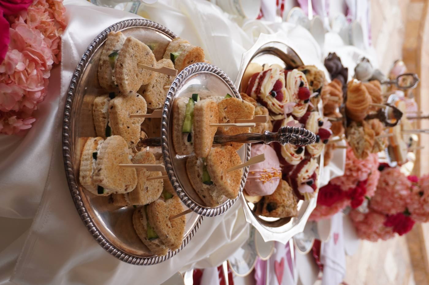 Tiered afternoon tea stand with sandwiches and cakes