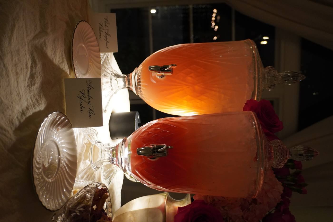 Glowing pink punch dispensers with rose florals