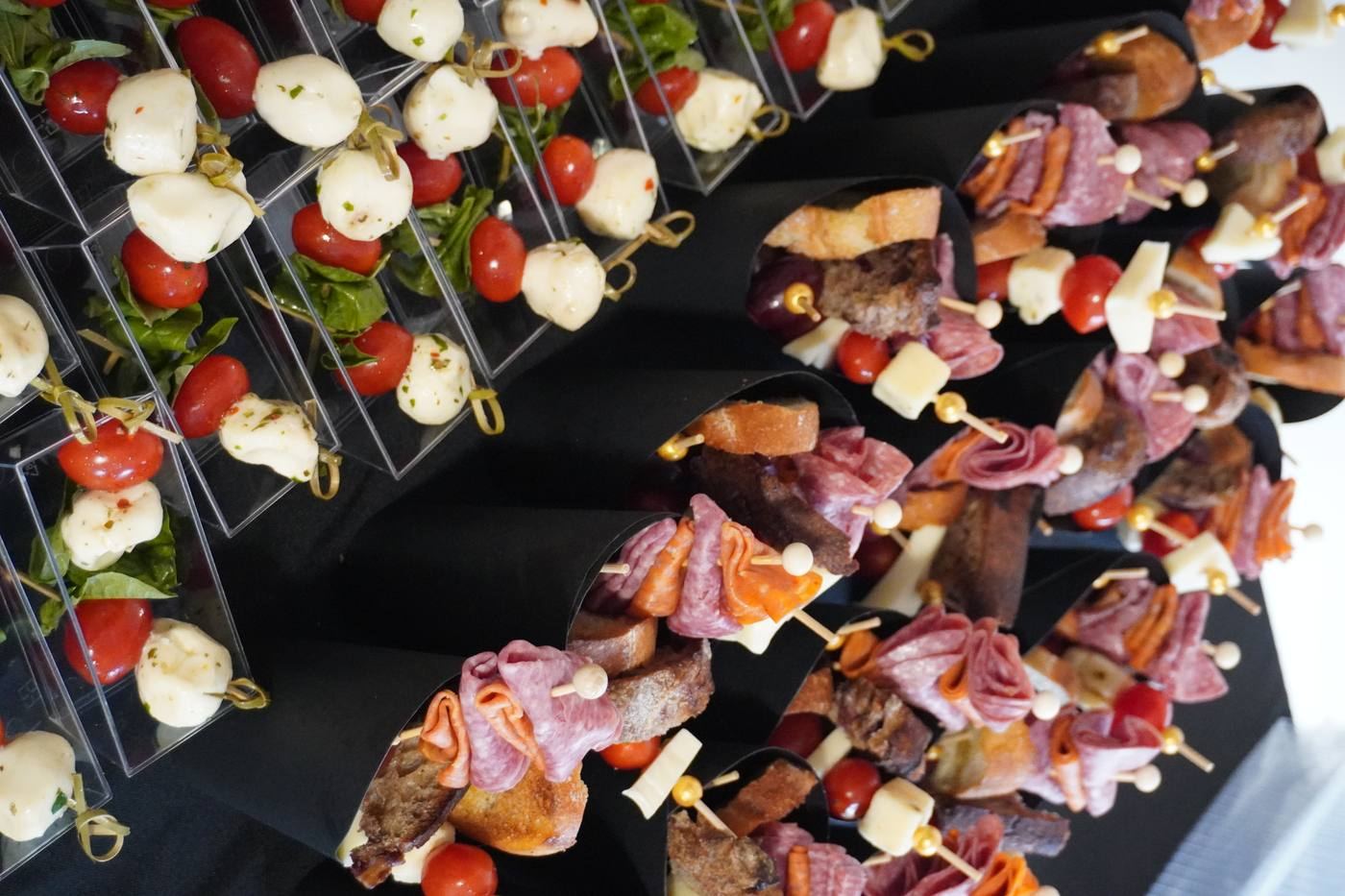 Charcuterie cones and caprese skewers plated display