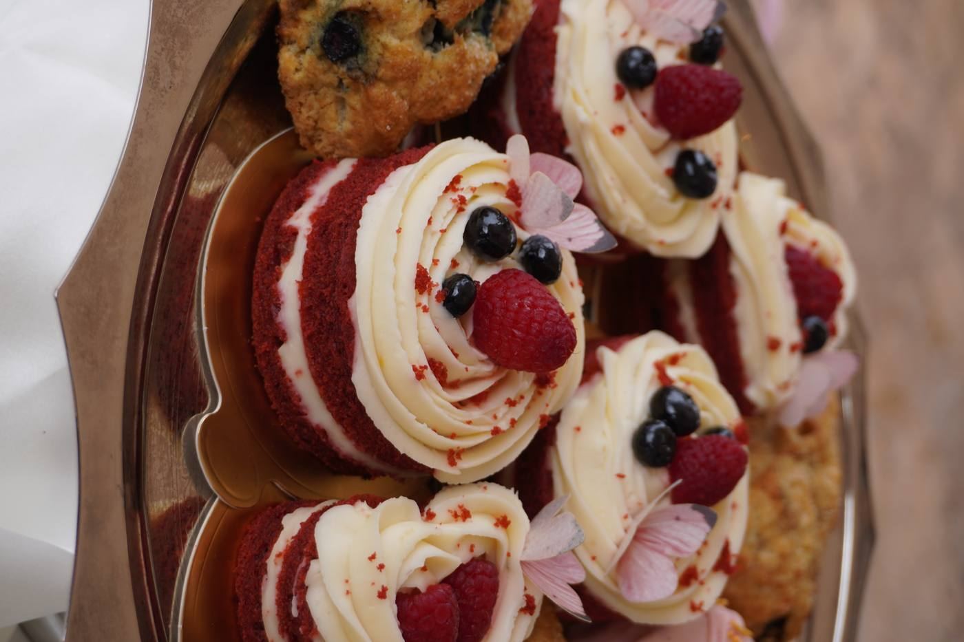 Red velvet mini cakes with berries and edible flowers