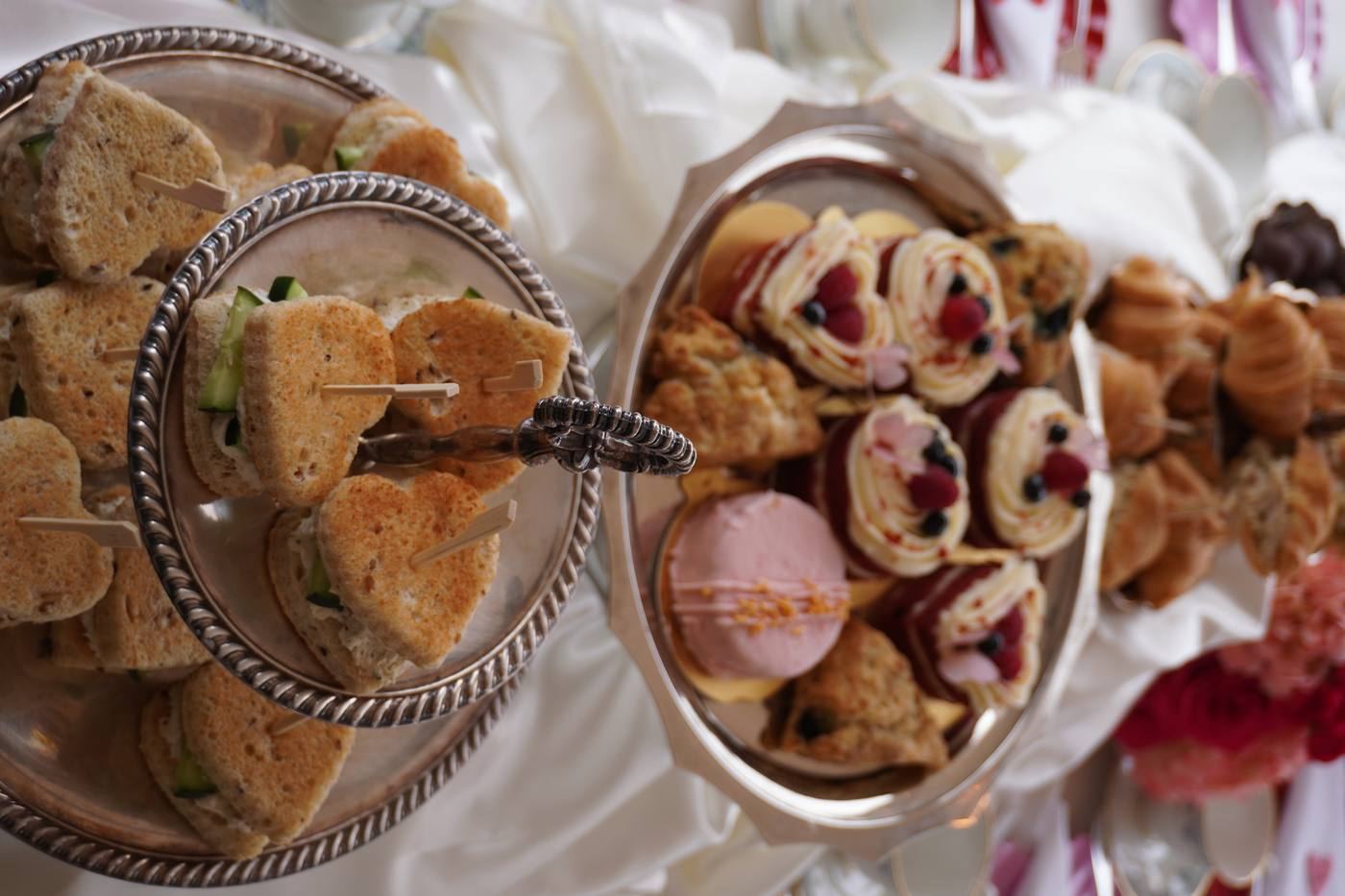 Tiered silver stand with tea sandwiches and pastries